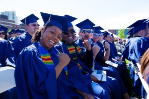 Graduates in caps and gowns celebrating the conclusion of the ASPIRE Colorado pilot program during a commencement ceremony.