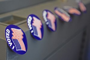 I voted" stickers on a metal surface, symbolizing participation in the election guided by the 2016 Ballot Guide.