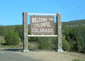 Welcome sign at the Colorado state border, featuring a futuristic automotive design.
