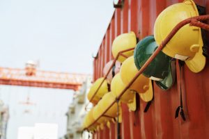 Safety helmets hanging on a rope at a middle-class entry construction site.