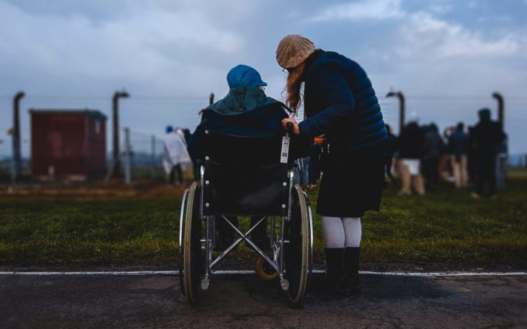 caregiver helping person in a wheelchair