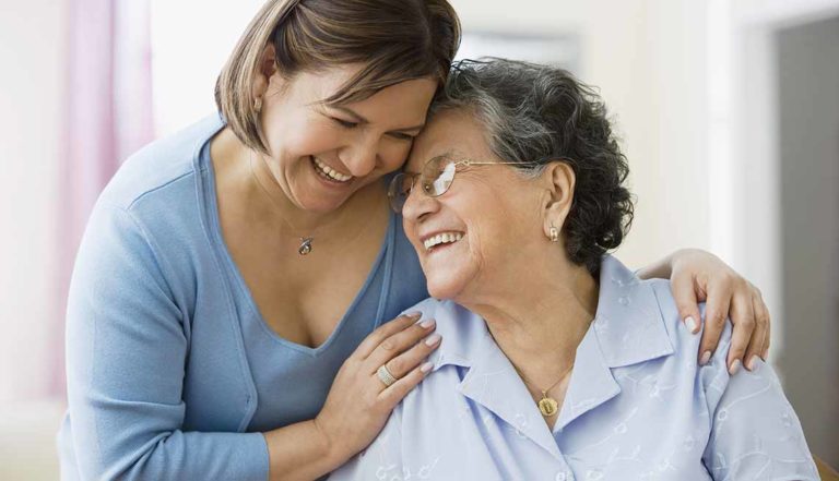 two women hugging, caregiving in colorado 2020