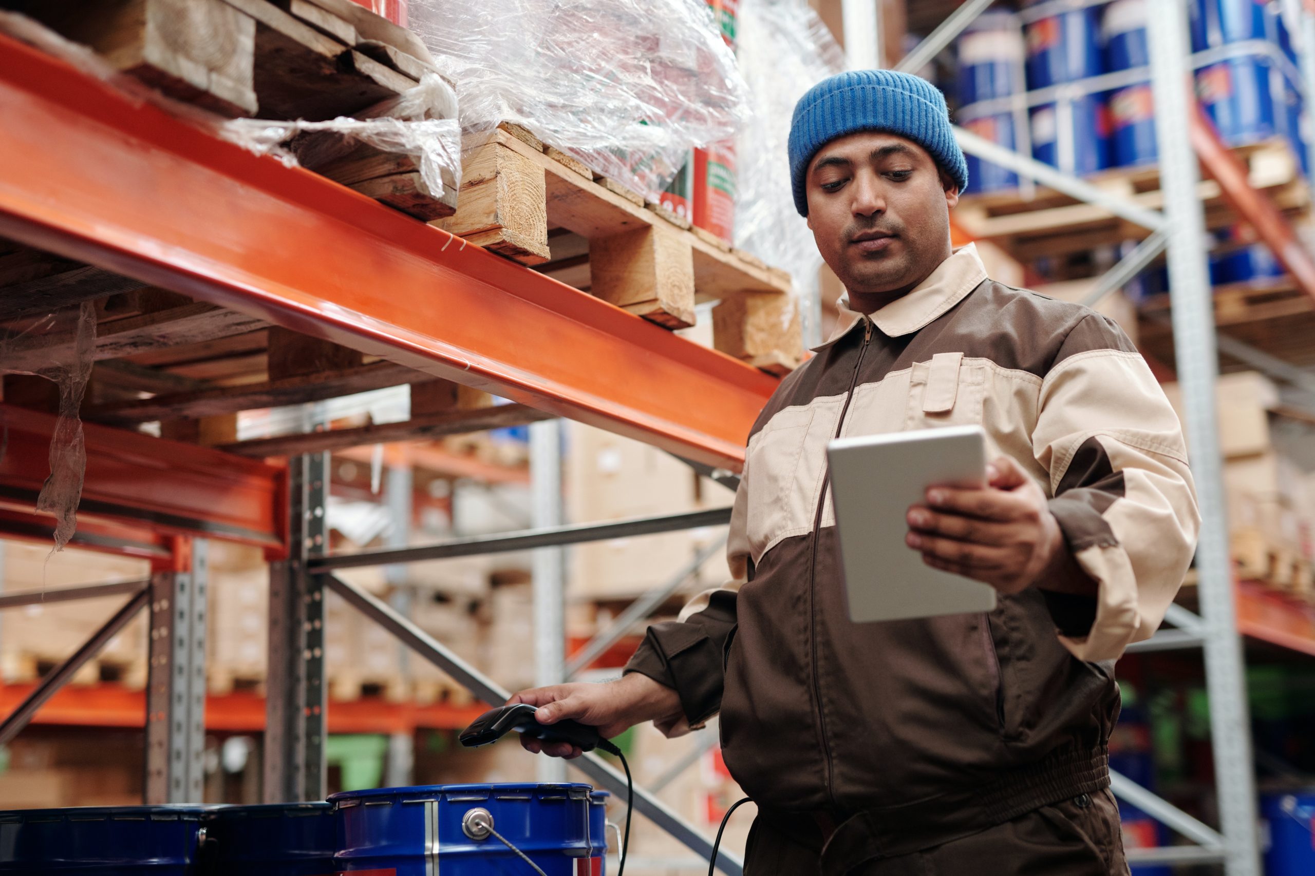 Warehouse worker in Aurora using a tablet for inventory management.