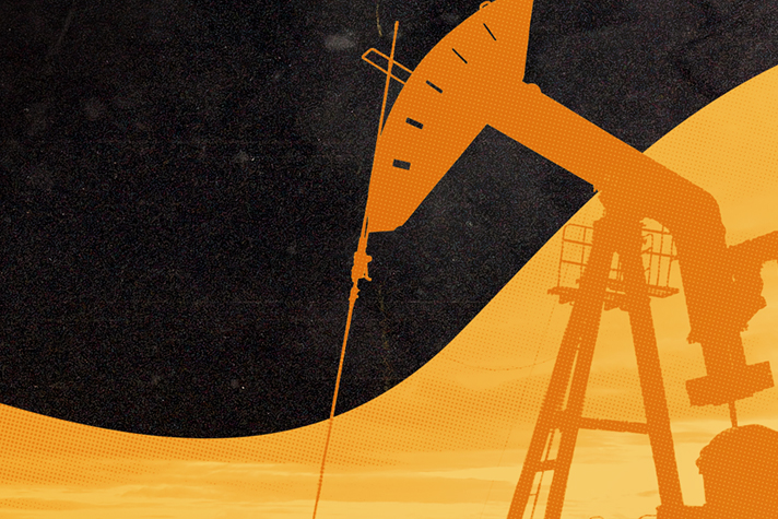 Silhouette of an orphan oil pump jack at sunset.